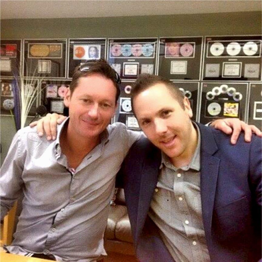 Matt with Chris Herbert in front of a wall of gold discs