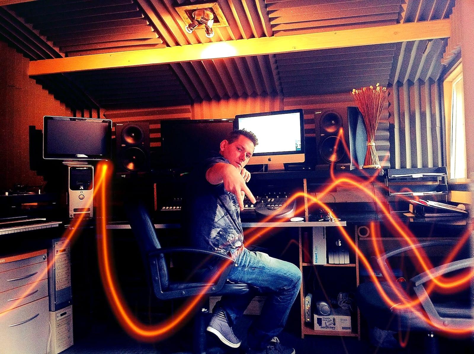 Warren at the desk in the studio with light trails