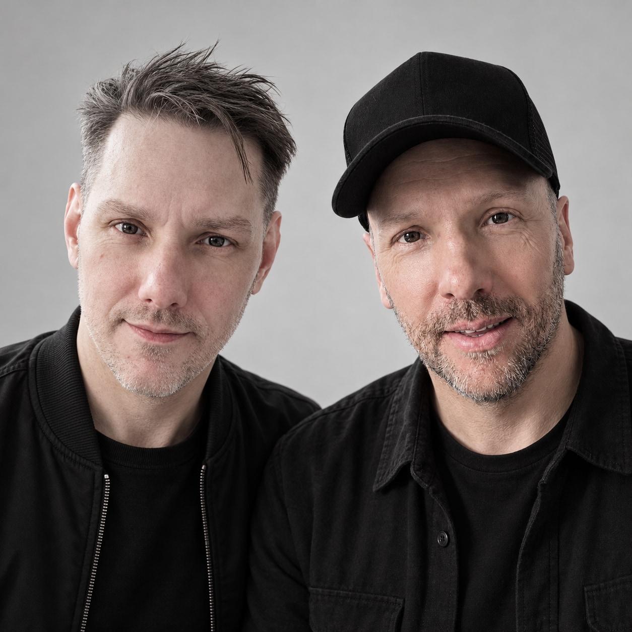 Matt and Warren Meyers of Soulshaker, colour portrait against a pale grey wall